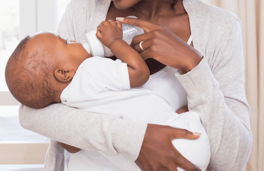 Woman with HIV feeds child with feeding bottle