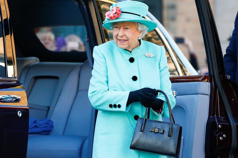 Queen Elizabeth holds her purse