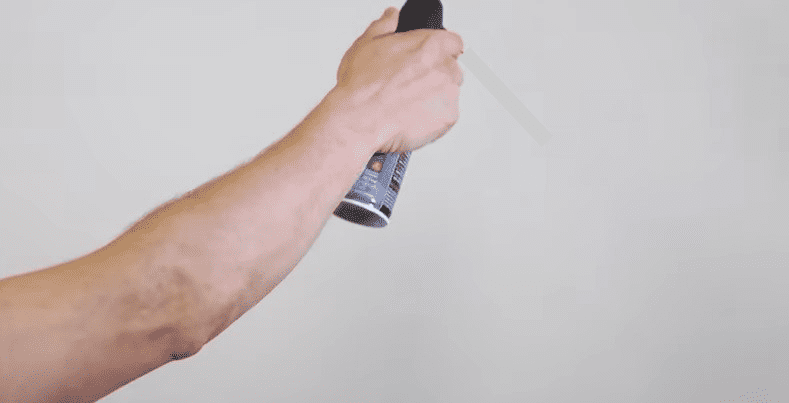 Spray compressed air on projector screen