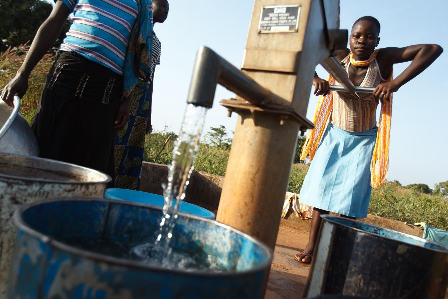 Girl pumps water